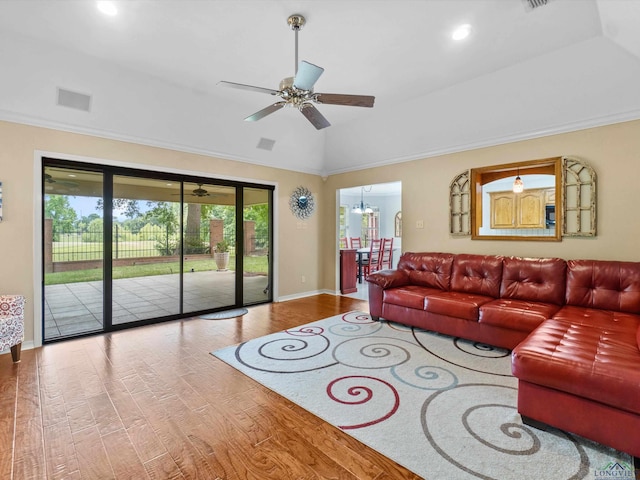 living room featuring ceiling fan, crown molding, vaulted ceiling, baseboards, and wood finished floors