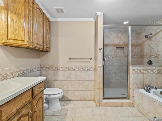 bathroom featuring a shower stall, crown molding, visible vents, tile walls, and tile patterned flooring