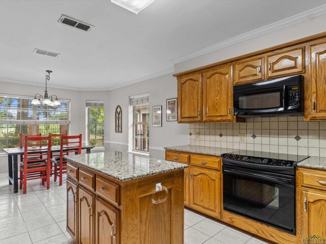 kitchen featuring visible vents, black appliances, and brown cabinets
