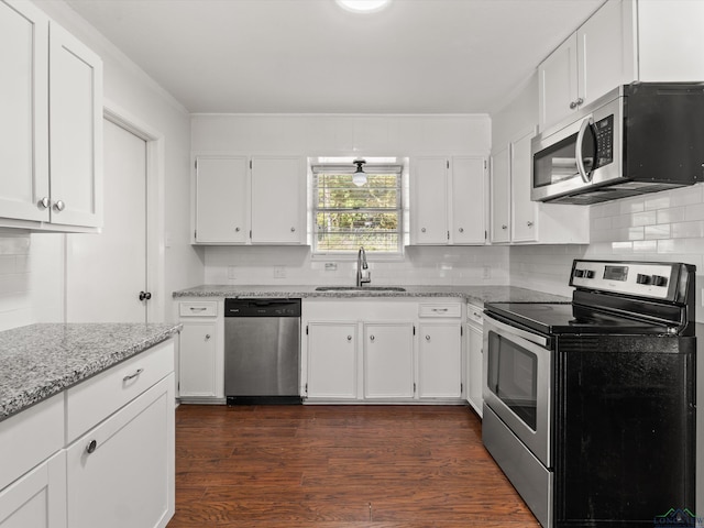 kitchen featuring white cabinets, appliances with stainless steel finishes, and sink