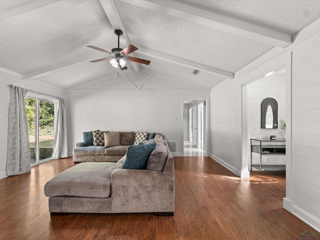 living room with vaulted ceiling with beams, a textured ceiling, dark hardwood / wood-style flooring, and ceiling fan