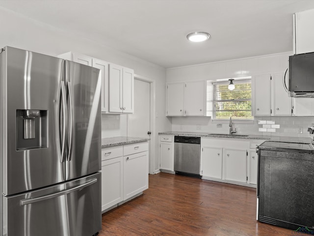 kitchen with light stone counters, sink, white cabinetry, and stainless steel appliances