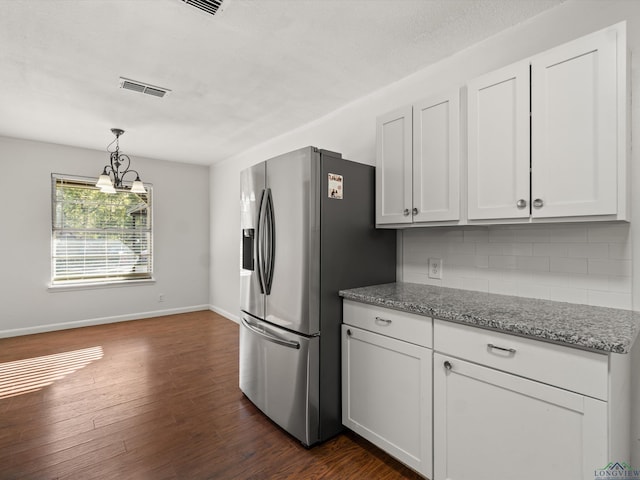 kitchen with white cabinets, stainless steel refrigerator with ice dispenser, decorative backsplash, decorative light fixtures, and light stone counters