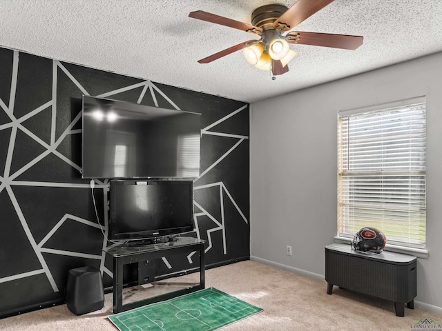 miscellaneous room featuring carpet flooring, ceiling fan, and a textured ceiling