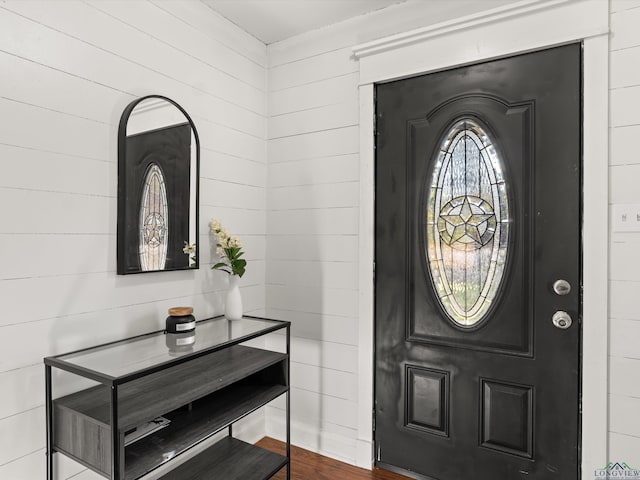 foyer featuring wooden walls and hardwood / wood-style flooring