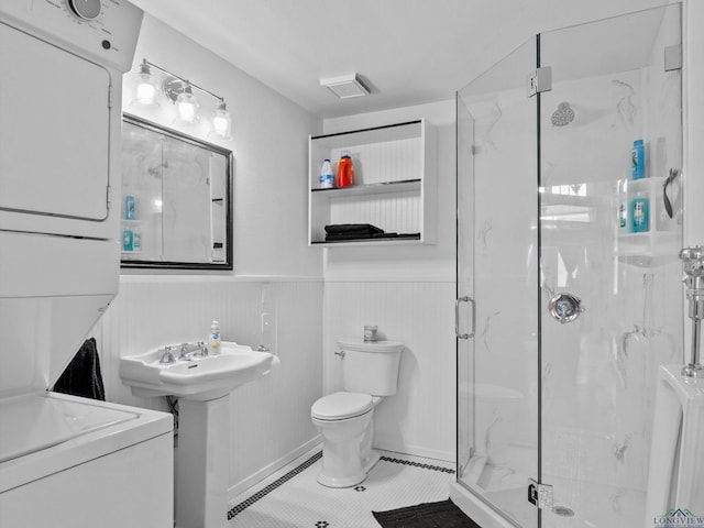 bathroom featuring sink, tile patterned flooring, a shower with shower door, and toilet