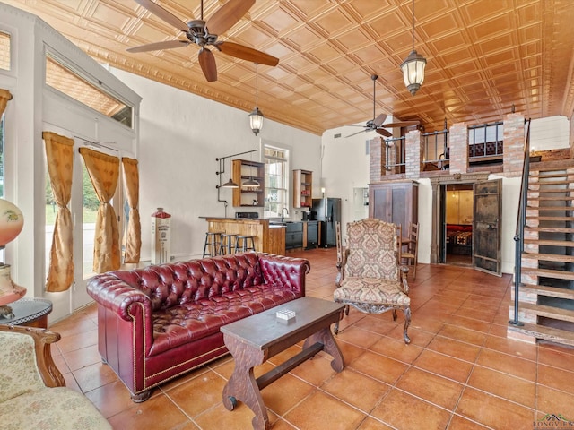 tiled living room featuring a high ceiling