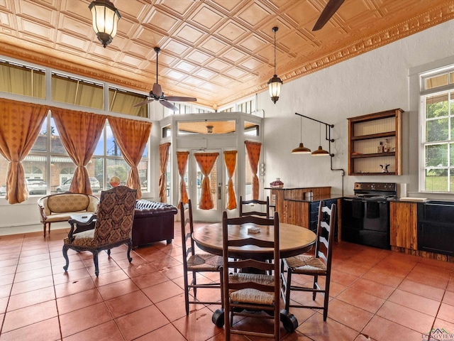 dining space featuring ceiling fan and tile patterned flooring