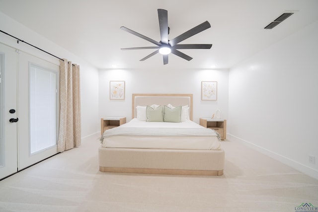 bedroom with baseboards, visible vents, ceiling fan, and light colored carpet