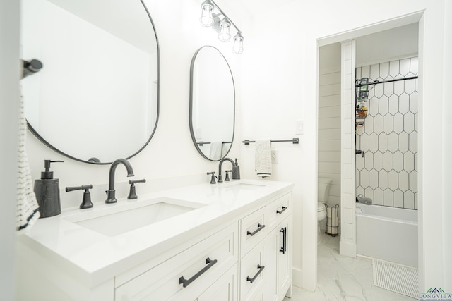 bathroom with marble finish floor, a sink, toilet, and bathtub / shower combination