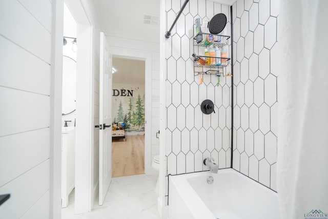 ensuite bathroom featuring visible vents, bathing tub / shower combination, toilet, ensuite bathroom, and marble finish floor