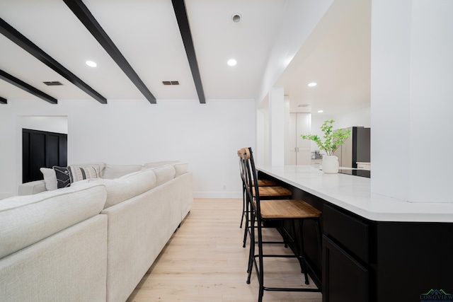 interior space featuring light wood-type flooring, visible vents, beam ceiling, and recessed lighting