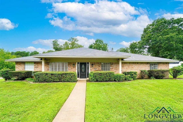 single story home with a front yard and brick siding