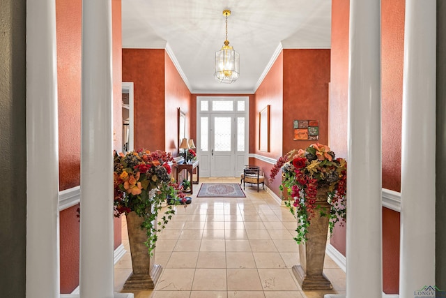 entrance foyer featuring light tile patterned floors, baseboards, a notable chandelier, and ornamental molding