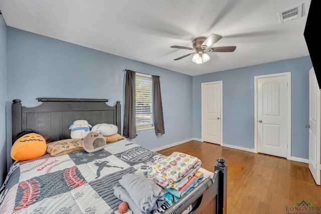 bedroom with ceiling fan and hardwood / wood-style flooring