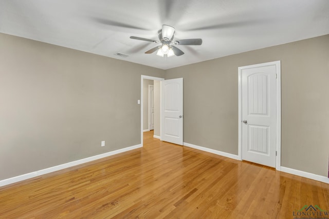 unfurnished bedroom with ceiling fan and light wood-type flooring