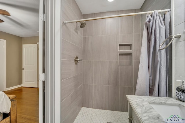 bathroom featuring curtained shower, hardwood / wood-style floors, and vanity