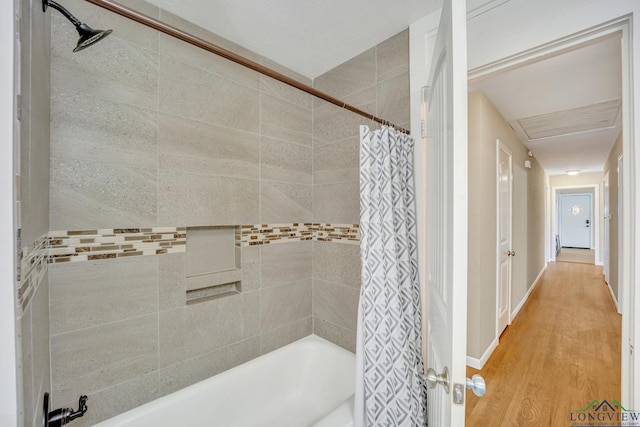 bathroom featuring shower / bathtub combination with curtain and wood-type flooring