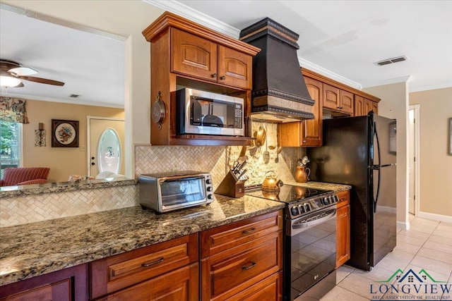 kitchen featuring stainless steel microwave, range with electric stovetop, custom range hood, ornamental molding, and tasteful backsplash