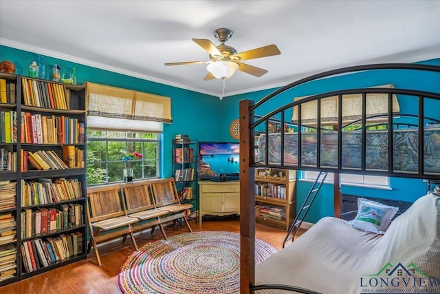sitting room featuring a ceiling fan, wood finished floors, and ornamental molding