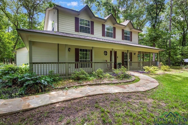 view of front facade featuring covered porch and a front yard