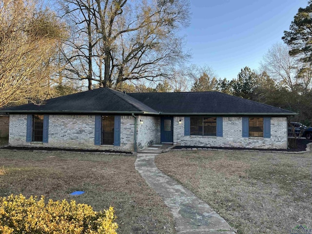 ranch-style home with a front yard