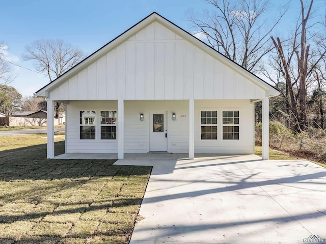 view of front of house with a patio area and a front yard