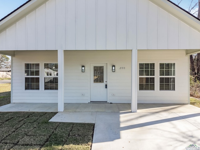 view of exterior entry featuring a patio area