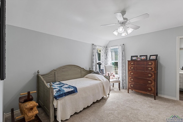 carpeted bedroom with ceiling fan and vaulted ceiling