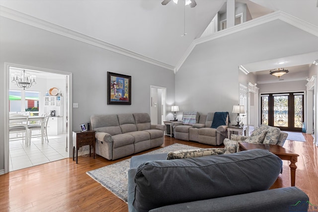 living room featuring ceiling fan, light hardwood / wood-style floors, crown molding, and high vaulted ceiling