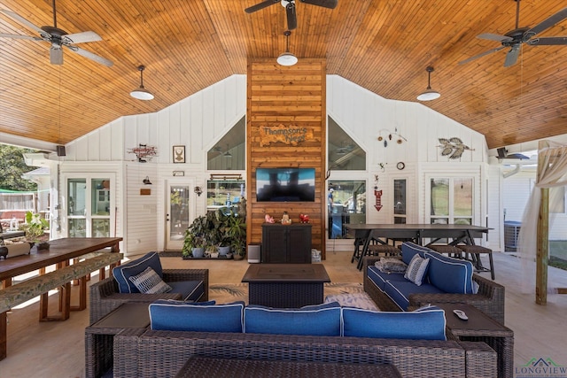 living room with wood walls and high vaulted ceiling