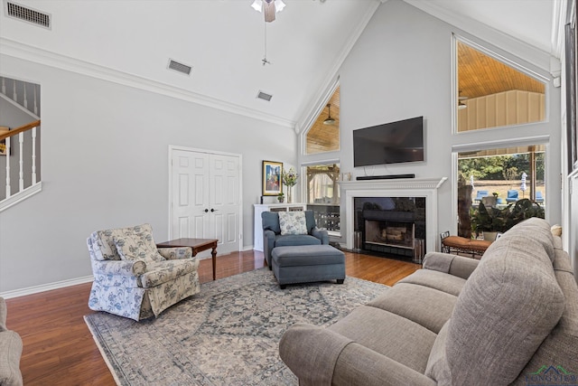 living room with hardwood / wood-style floors, high vaulted ceiling, and ceiling fan