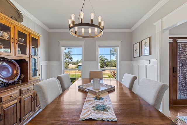 dining room with a notable chandelier, dark hardwood / wood-style flooring, and ornamental molding