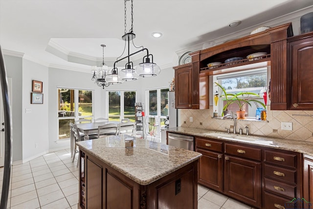 kitchen featuring a raised ceiling, crown molding, sink, stainless steel dishwasher, and a kitchen island