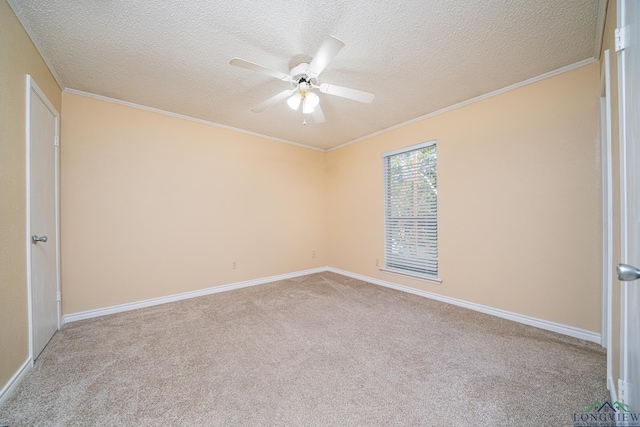 spare room featuring a textured ceiling, ceiling fan, light colored carpet, and crown molding