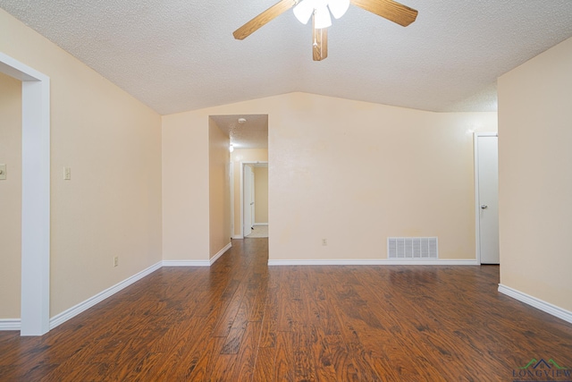 spare room with vaulted ceiling, ceiling fan, dark wood-type flooring, and a textured ceiling