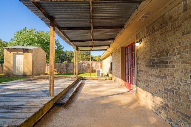 view of patio with central AC and a storage unit