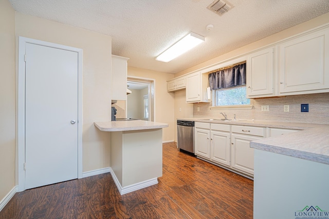 kitchen with white cabinets, dark hardwood / wood-style flooring, a textured ceiling, and dishwasher