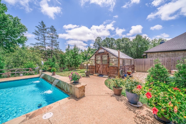 2106 Katie Lee Ln, Longview, TX 75601 - view of swimming pool with an exterior structure, a fenced backyard, an outbuilding, and a patio area