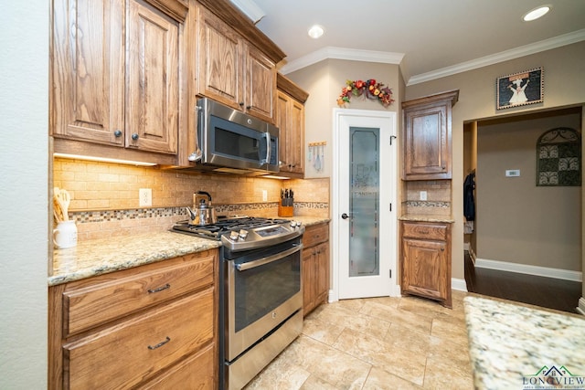 2106 Katie Lee Ln, Longview, TX 75601 - kitchen featuring stainless steel appliances, decorative backsplash, light stone counters, crown molding, and brown cabinets