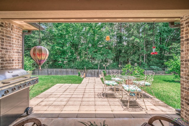 2106 Katie Lee Ln, Longview, TX 75601 - fenced backyard with a grill, a patio area, and outdoor dining space