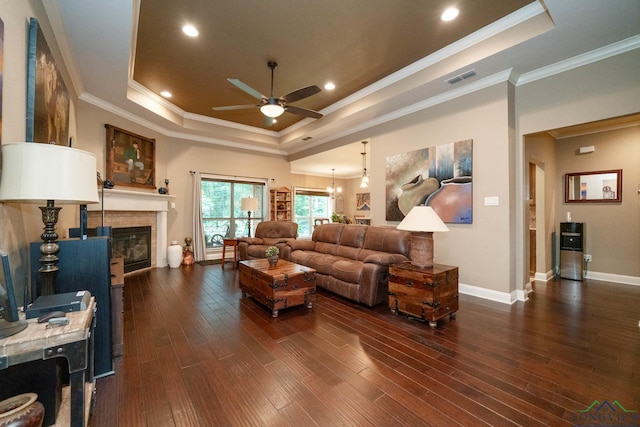 2106 Katie Lee Ln, Longview, TX 75601 - living area with a tray ceiling, ceiling fan, dark wood finished floors, a glass covered fireplace, and baseboards