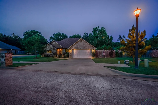 2106 Katie Lee Ln, Longview, TX 75601 - view of front of home with an attached garage, driveway, and stone siding