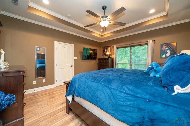 2106 Katie Lee Ln, Longview, TX 75601 - bedroom featuring a raised ceiling, light wood-type flooring, ornamental molding, baseboards, and ceiling fan