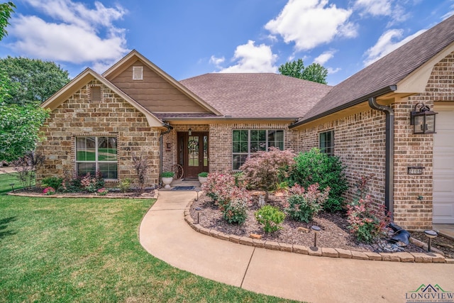 2106 Katie Lee Ln, Longview, TX 75601 - view of front facade with a front yard, roof with shingles, and brick siding