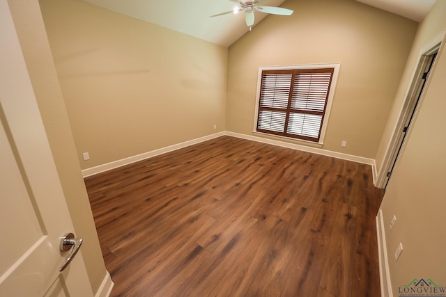 empty room with dark hardwood / wood-style flooring, vaulted ceiling, and ceiling fan