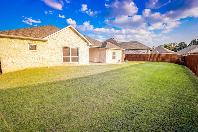 back of house featuring a yard