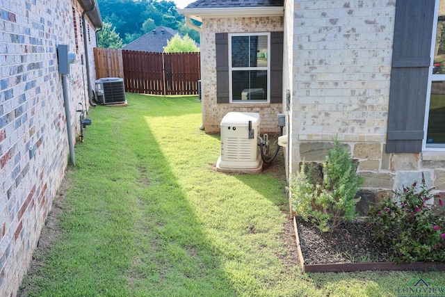 view of yard featuring central air condition unit