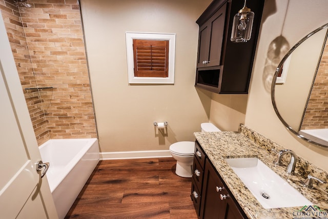 bathroom with toilet, vanity, and hardwood / wood-style flooring