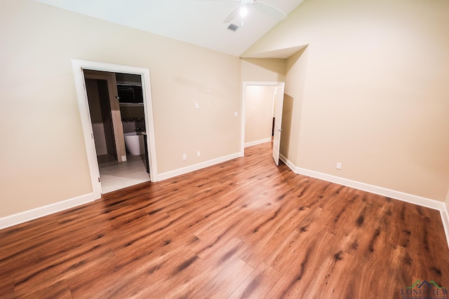 unfurnished room with lofted ceiling and wood-type flooring